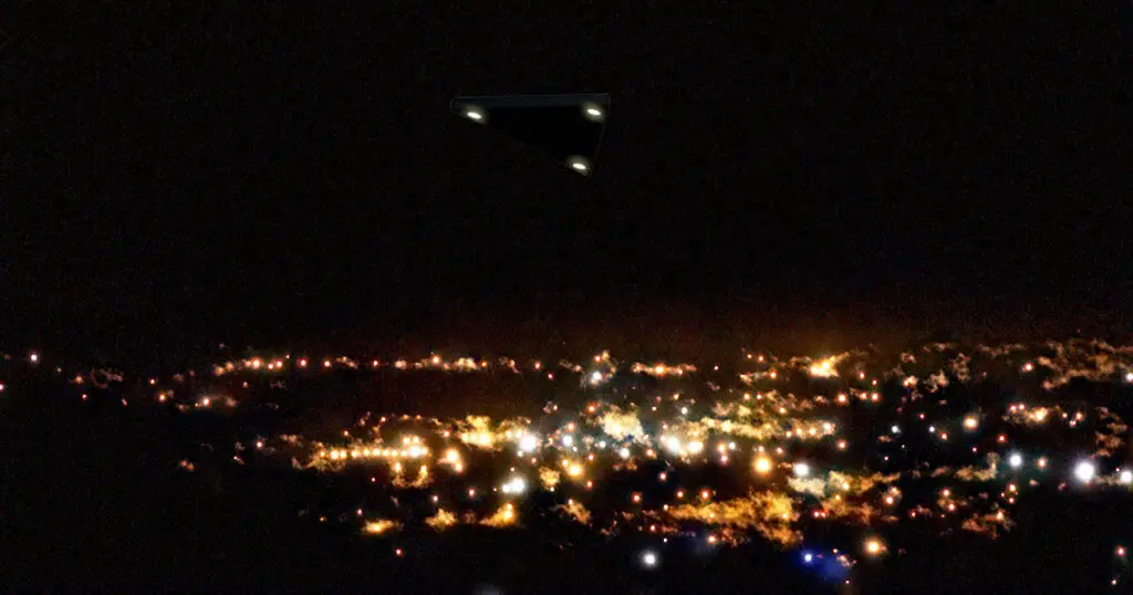 Triangular UFO with bright lights over the illuminated cityscape of Jerusalem at night.